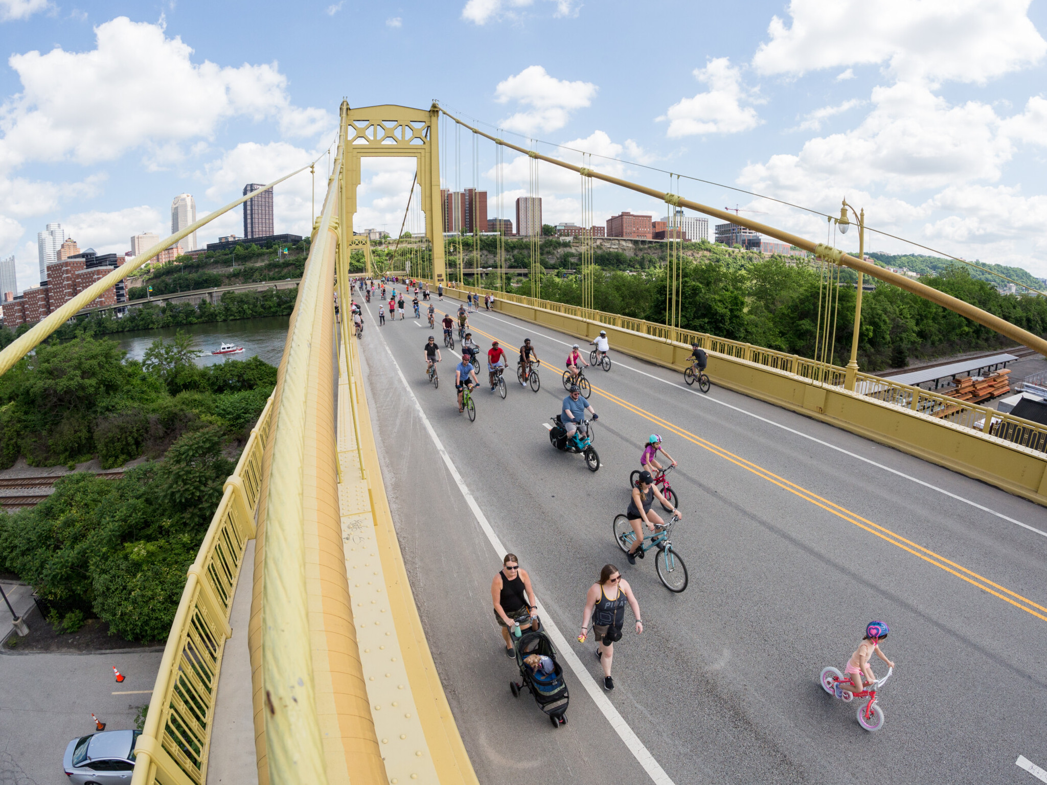 People walking and biking on a bridge in Pittsburgh
